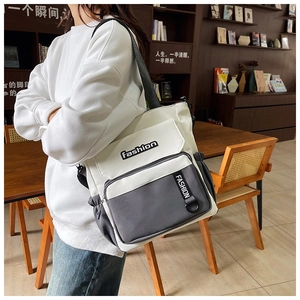 Close-up of color-block casual crossbody bag with fashion print and multiple pockets