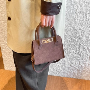 Brown minimalist tote bag with gold hardware and top handles for women commute style