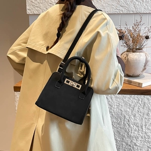Minimalist black leather tote bag with silver square lock buckle and dual carry style