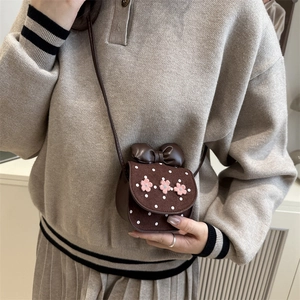 Cute brown polka dot mini shoulder bag with pink floral accents and bow for girls