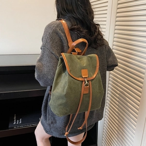 Retro dark green canvas backpack with brown leather straps and drawstring closure