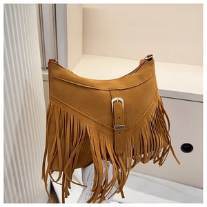 Detailed view of brown suede tassel bag featuring vintage metal buckle and fringe