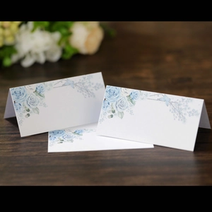 Blue rose floral lace hollow place cards for wedding seating arrangements on wood
