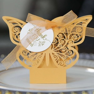 Elegant laser-cut butterfly wedding candy box in yellow with ribbon and thank you tag