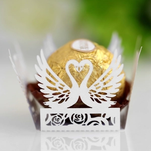 Laser-cut white paper chocolate holder with heart swan design for weddings