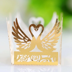 Golden laser-cut wedding favor box with swan heart design and rose lace patterns