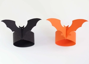 Halloween bat napkin rings in black and orange cardstock for festive party table decor