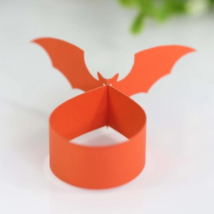 Orange bat-shaped paper napkin ring for Halloween festive table decoration and party supply