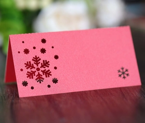 Pink laser-cut snowflake place card in pearlescent paper for wedding table seating