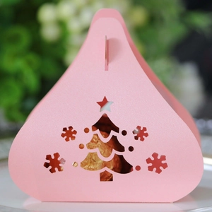 Pink triangular Christmas candy box with hollow tree design and golden chocolate inside