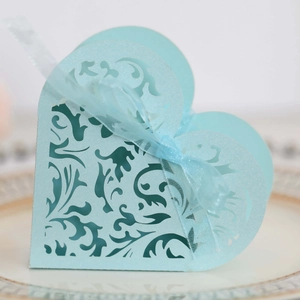 Laser-cut light blue heart-shaped favor box with vine pattern and ribbon for wedding