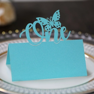 Laser cut bright blue butterfly table card with One lettering for first birthday party