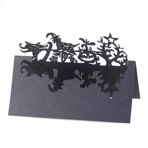 Laser-cut black Halloween place card with spider web pumpkin and castle silhouette