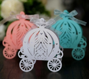 Elegant laser cut pumpkin carriage favor boxes with ribbons in pink white and blue colors