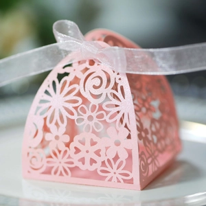 Pink laser-cut floral wedding candy gift box with elegant white organza ribbon bow