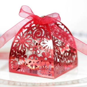 Elegant laser-cut red hollow wedding candy gift box with a delicate organza ribbon bow