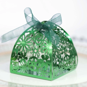 Laser-cut green metallic favor box with floral patterns and a matching organza ribbon bow