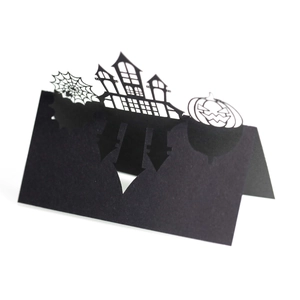 3D laser cut Halloween place card with castle spider web and pumpkin on white background