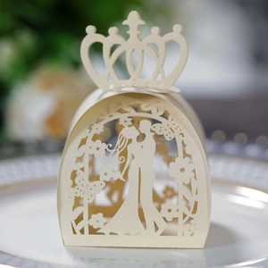 Creamy white laser-cut wedding favor box with crown top and bride and groom silhouette