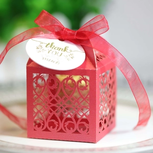 Elegant laser-cut red favor box with red ribbon and thank you tag for weddings