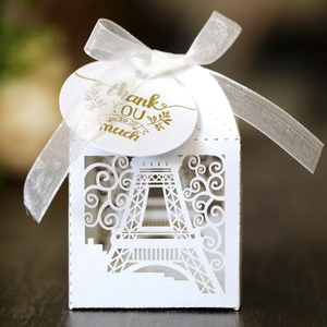 Laser-cut white Eiffel Tower gift box with ribbon and thank you tag for wedding favors