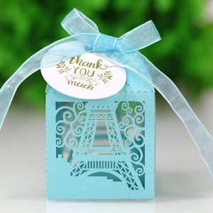 Light blue laser-cut Eiffel Tower candy favor box with ribbon and thank you tag