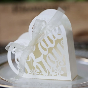 Elegant white laser-cut heart wedding candy box with Love You text and ribbon