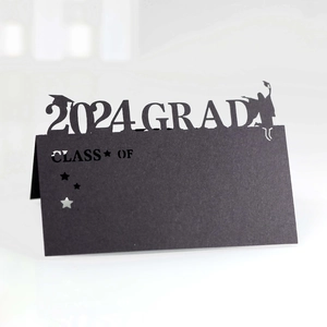 Detail showing the laser-cut 2024 Grad silhouette on black cardstock place card