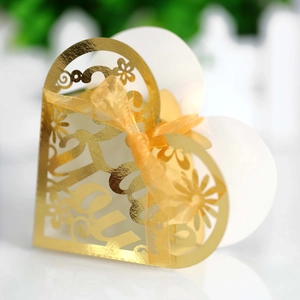 Golden heart shaped hollow gift box with elegant laser cut floral pattern and ribbon