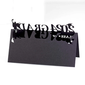 Detail of 2024 GRAD laser cut black paper place card with mortarboard silhouettes