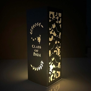 Class of 2024 laser-cut black paper candle holder sleeve with warm light effect