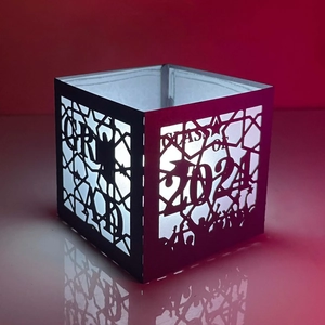 Black Class of 2024 graduation paper-cut lamp shade with glowing student silhouettes