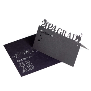 Detailed laser cut graduation place card with 2024 GRAD design and hollowed silhouette