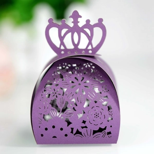 Elegant purple laser-cut wedding favor box with intricate floral hollow design and crown handle