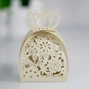 Elegant laser-cut beige favor box with crown top and floral hollow design for weddings