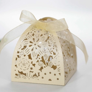 Champagne laser-cut wedding candy box with elegant floral hollow patterns and ribbon