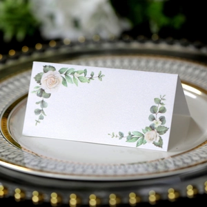 Elegant white floral place card with rose print on gold rimmed porcelain plate for weddings