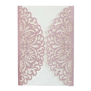 Pink glitter laser-cut invitation with symmetrical floral mandala pattern on white background