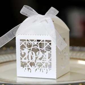 Detail of laser-cut Class of 2024 graduation favor box with elegant white ribbon bow