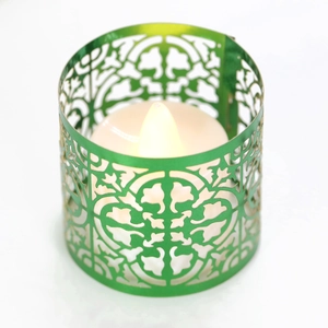 Green metal hollow candle holder with vintage floral patterns and LED tea light