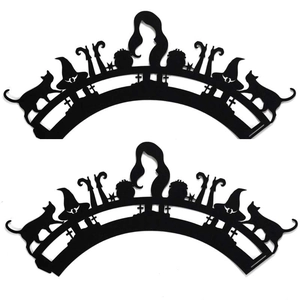 Halloween cupcake wrappers featuring laser-cut black witch and cat silhouette decorations