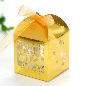 Macro detail of laser-cut 2024 graduation candy box with metallic gold finish and silk ribbon