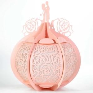 Pink laser-cut paper lantern featuring romantic couple silhouette and rose patterns