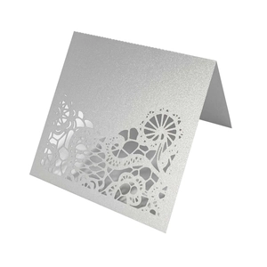 Silver laser-cut place cards with glitter finish and elegant floral lace patterns