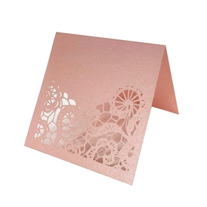 Laser cut rose gold glitter wedding place cards with intricate hollow geometric pattern