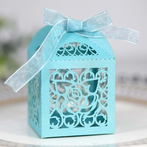 Detailed laser-cut rose patterns on light blue wedding candy box with silk ribbon bow
