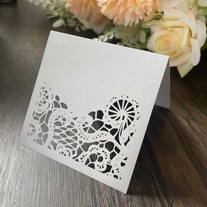 Elegant white laser-cut lace place card made of pearlescent paper for wedding table decor