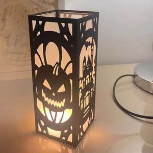 Halloween black hollowed lantern with pumpkin and gothic castle silhouette and warm LED light