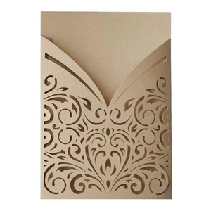 Laser cut champagne gold wedding invitation with intricate hollow heart and floral design