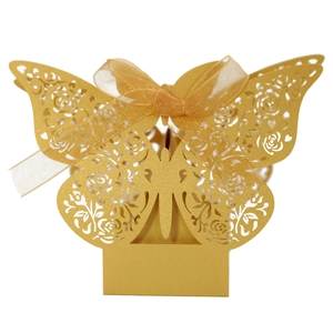 Elegant gold laser cut candy box with rose patterns and yellow ribbon for wedding favors